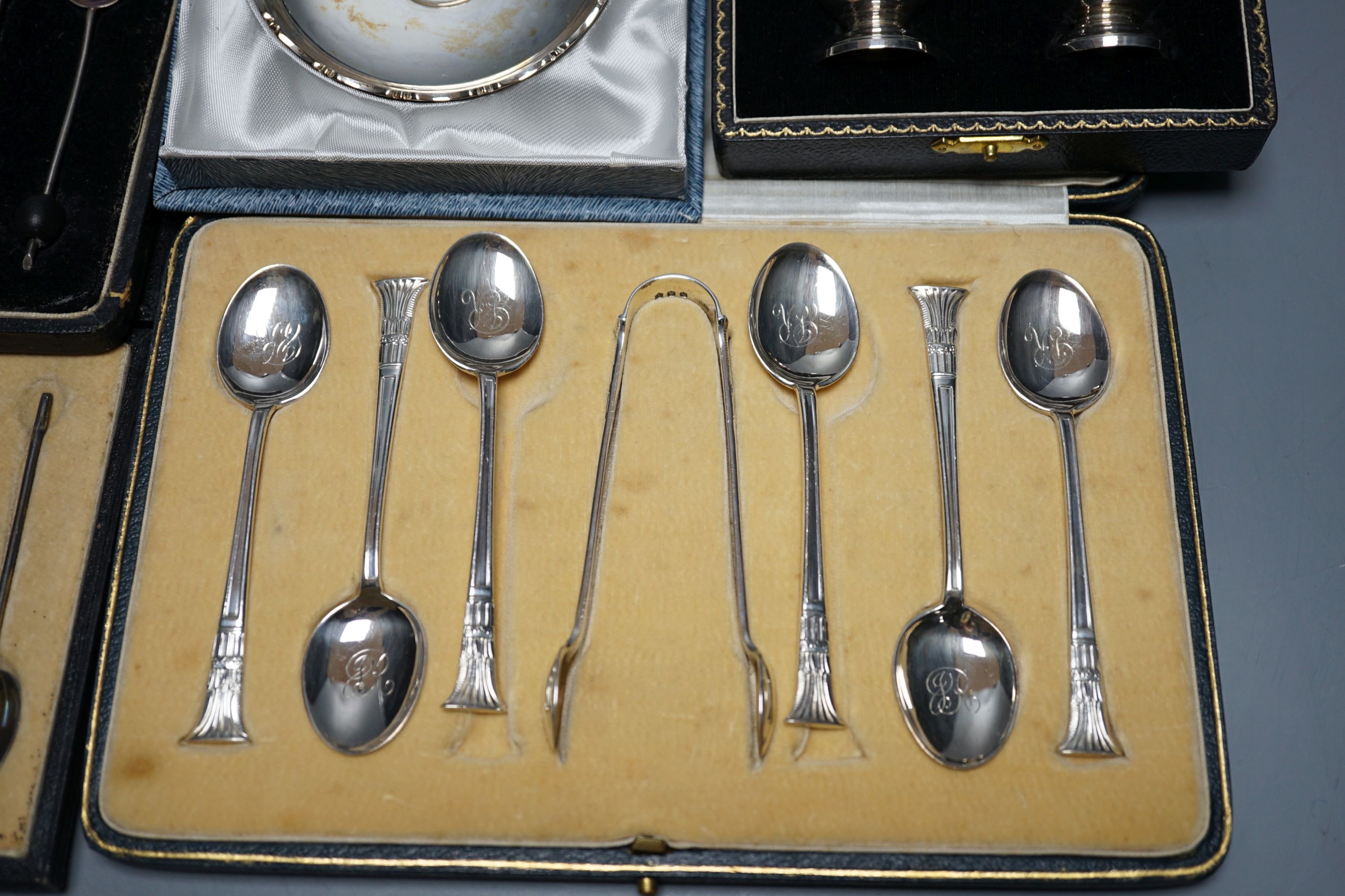 Two cased sets of six silver coffee spoons including enamel(a.f.) and bean end and three other cased sets including teaspoons with tongs, pepperettes and dish.